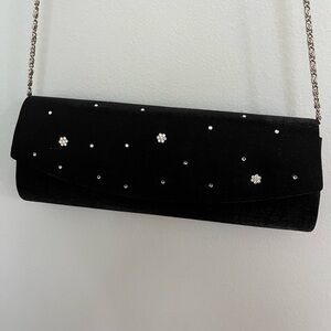 Star studded evening clutch bag with removable chain strap.
